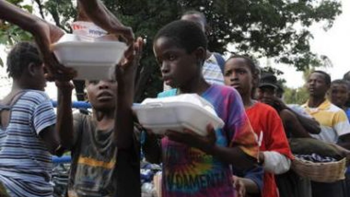 Los niños hacen cola para recibir algo que comer.