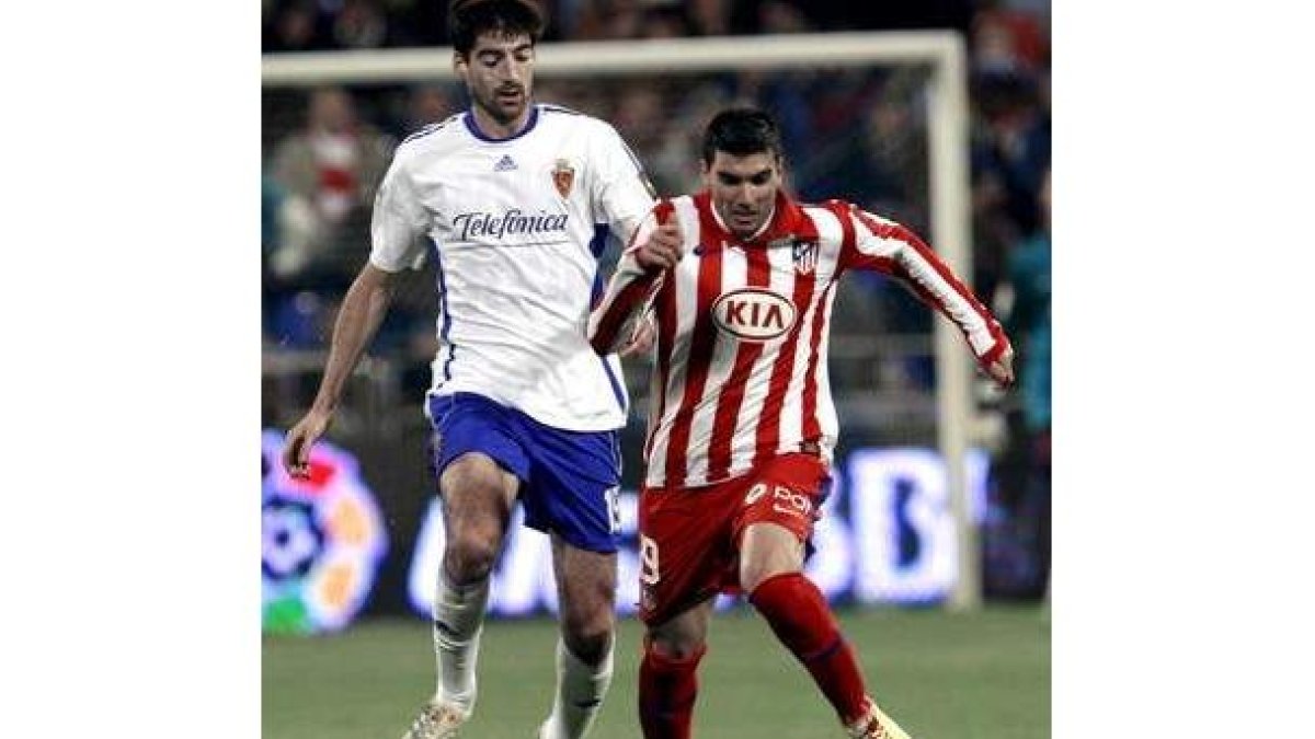 José Antonio Reyes intenta avanzar con el balón ante el maño Arizmendi.