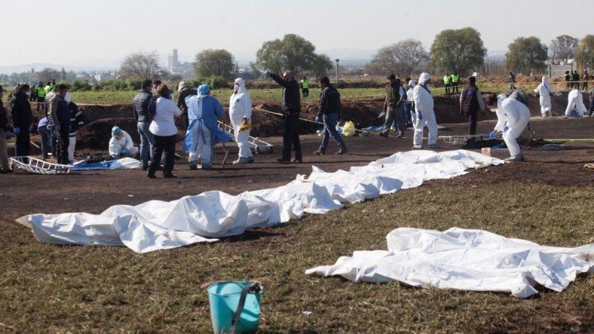 Expertos forenses registran la zona cerca de una toma clandestina de gasolina de Petroleos Mexicanos (Pemex).