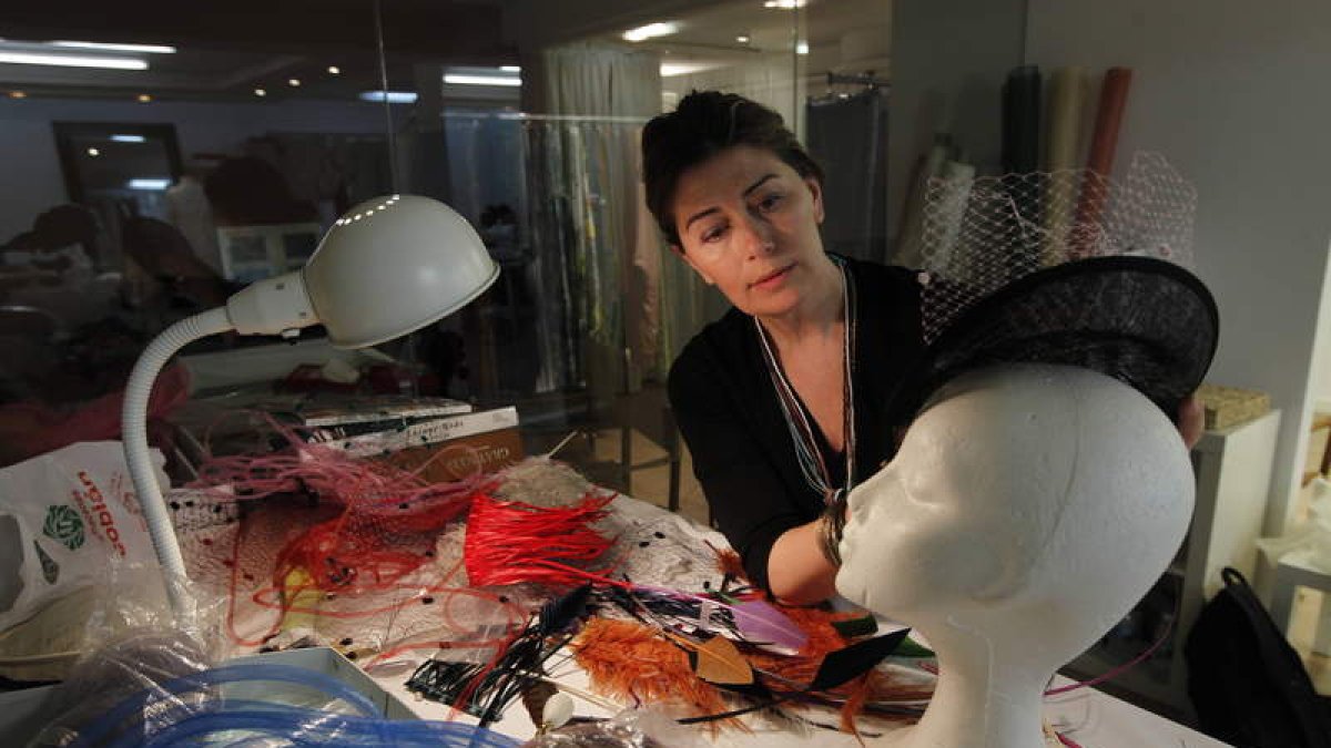 Marina Sánchez da los últimos retoques a un tocado de fiesta en una de las mesas de trabajo de su estudio. La elaboración es totalmente artesanal y en cada una de sus piezas utiliza materiales de primera calidad.