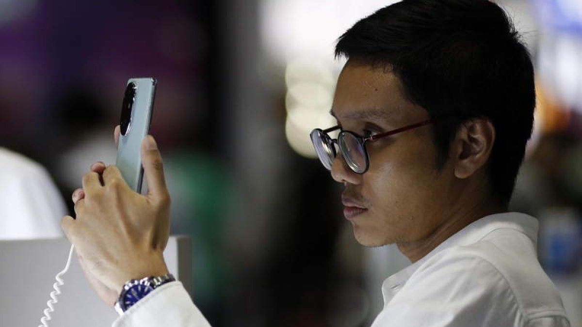 Un hombre maneja un teléfono móvil.  efe