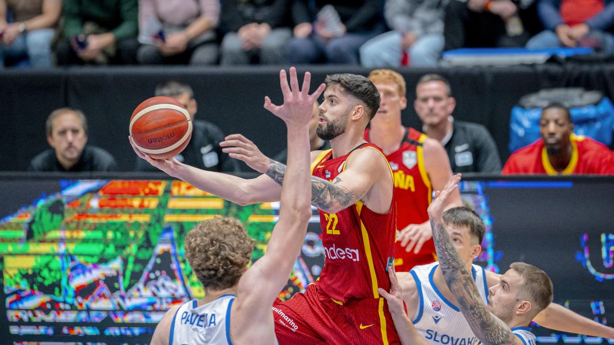 El alero de España Santi Yusta (c) entra a canasta durante el partido Eslovaquia-España de clasificación para el Eurobasket 2025 disputado este viernes en Bratislava. EFE/FEB