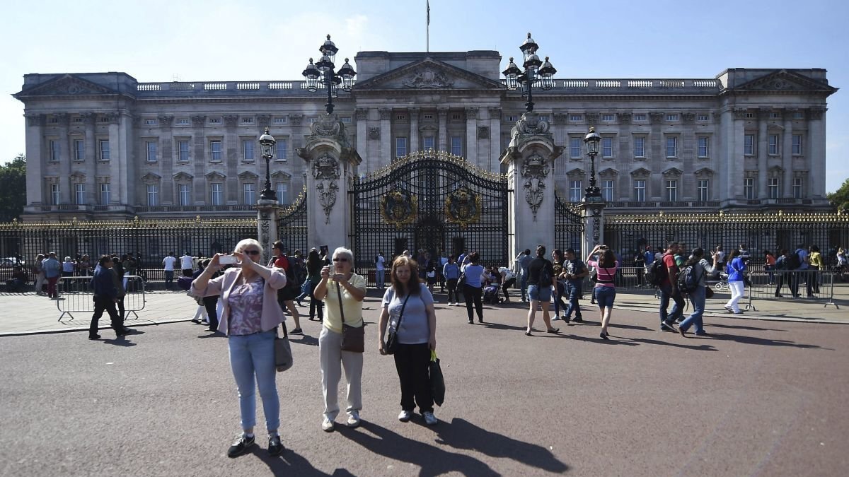 Un grupo de turistas frente al palacio de Buckingham en Londres. Andi Rain