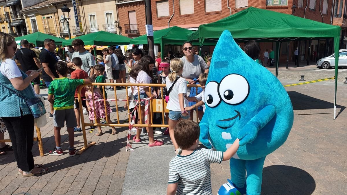 La mascota de Iriego atiende a uno de los niños.