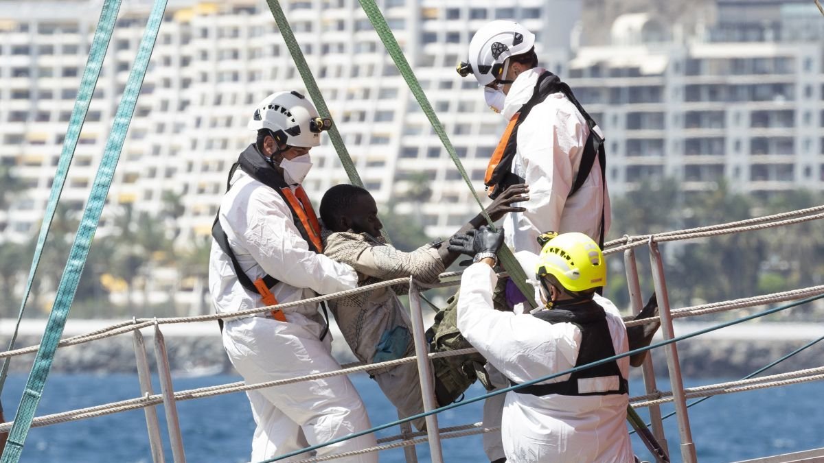 Equipos de rescate ayudan a un migrantes en el puerto de Puerto de Arguineguín.