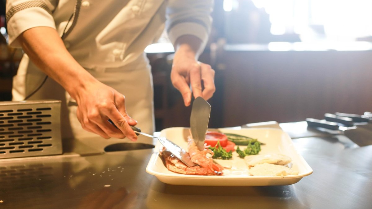 Un cocinero prepara un plato en un restaurante