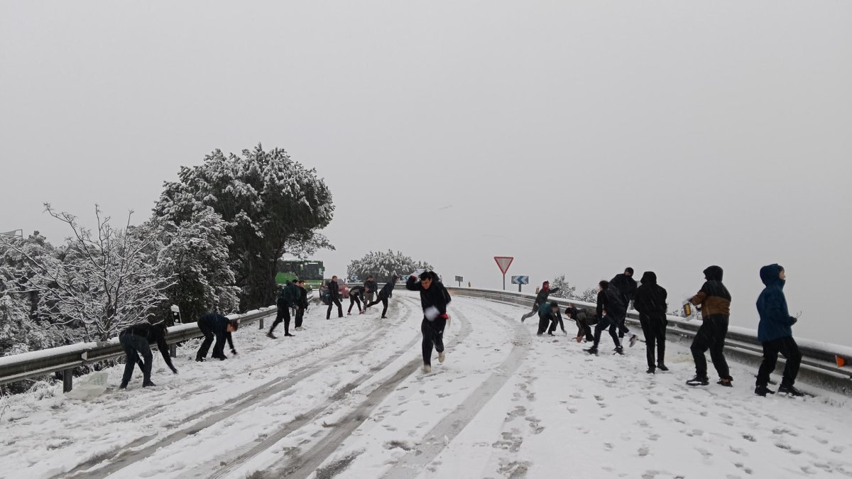 Varias personas se lanzan bolas de nieve en la carretera M-519 a la altura de Galapagar, este miércoles, en el que la borrasca Kristin deja una nevada en la región de Madrid. EFE/Álvaro Blanco.