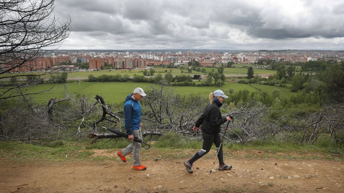 Dos viandantes pasean por Las Lomas.