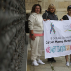 María Luisa, Luz Divina y Silvia Vega, ayer en Botines con el cartel del Día Mundial. FERNANDO OTERO