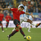 El defensa del Osasuna Miguel Flaño pelea un balón con el delantero del Málaga, Rondón.
