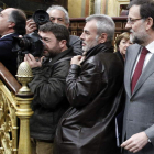 Rajoy pasa al lado de los fotógrafos en el Congreso mientras fotografían a Montoro.