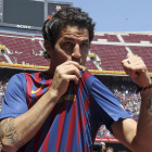 Cesc Fábregas besa el escudo del que es su nuevo equipo después de firmar ayer su contrato.