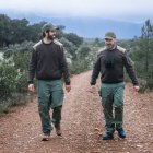 Agentes medioambientales en plena jornada de vigilancia forestal, recorriendo un camino rural en un entorno protegido