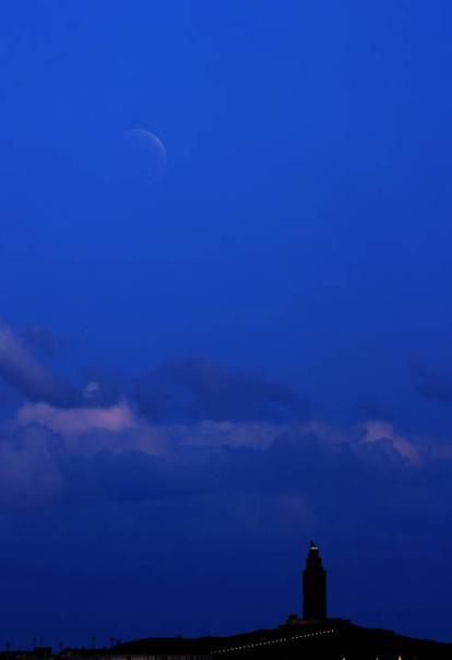 Eclipse de Luna visto desde el concello coruñés de Oleiros con la Torre de Hércules en primer término.